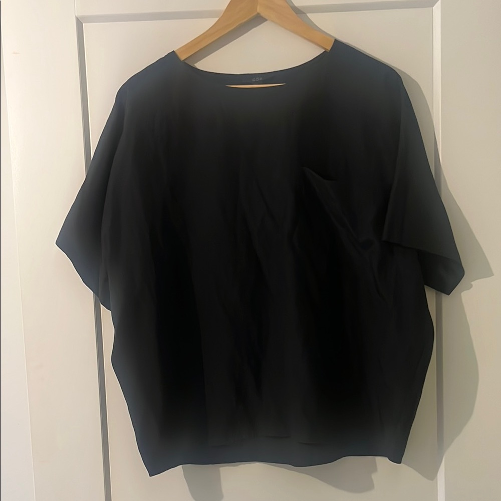Boxy “silky” black oversized top with large pocket on chest
